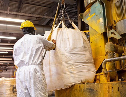 Benjamin Moore employees working with raw materials in a Benjamin Moore warehouse.