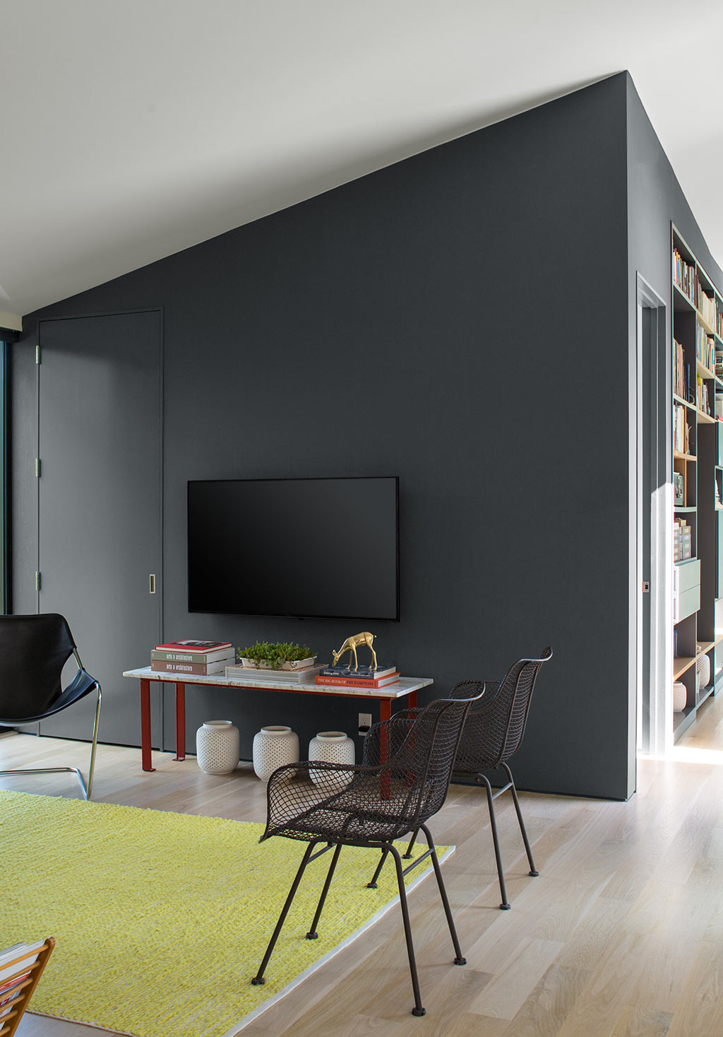 Contemporary living room with dark gray feature wall