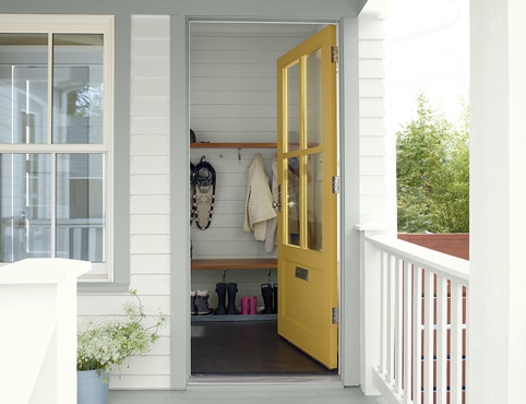 An exterior door of a home painted in yellow An exterior door of a home painted in yellow