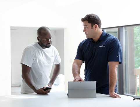 Painting contractors reviewing a painting estimate.