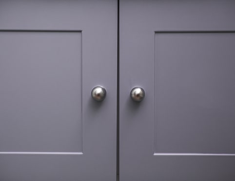 Grey coloured cabinet doors.