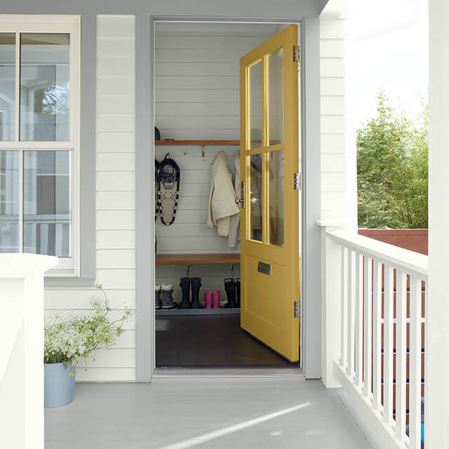 An exterior door of a home painted in yellow