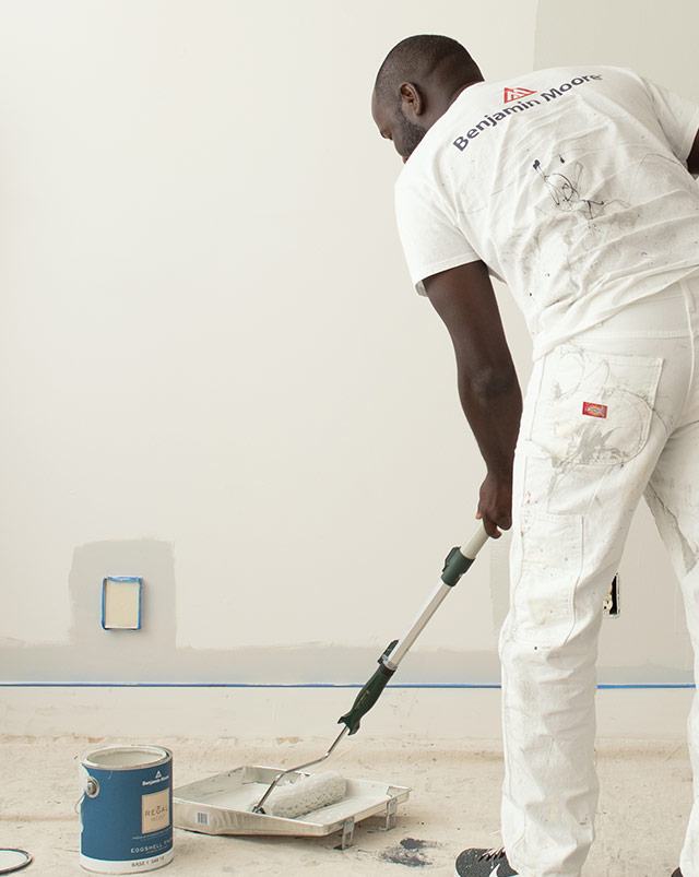 A pro painter loads his roller