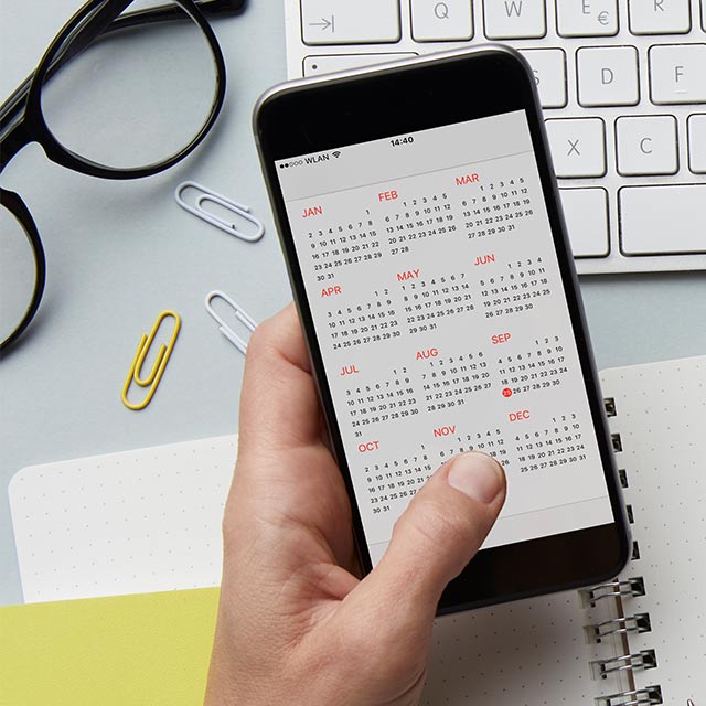 A contractor looks over their schedule on their phone