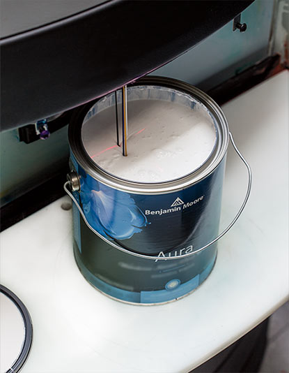 A can of Benjamin Moore paint is being tinted with Gennex® Colour Technology. A can of Benjamin Moore paint is being tinted with Gennex® Colour Technology.