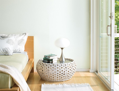 Bright, airy bedroom with white walls and a low profile bed