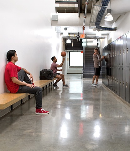 Athletes gather in a crisp, clean locker room, an example of what SCUFF-X can do for spaces that typically scuff and stain.