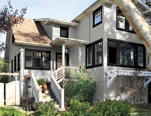 Exterior rendering of a house with white siding and black trim.