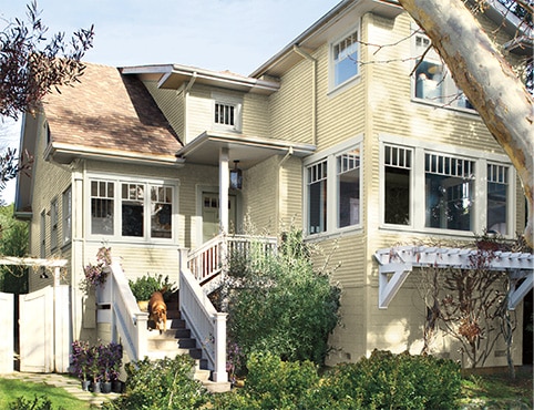 Exterior rendering of a house with yellow siding and white trim.