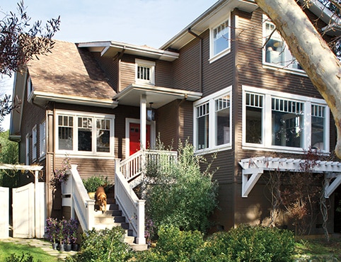 Exterior rendering of a house with brown siding and white trim.