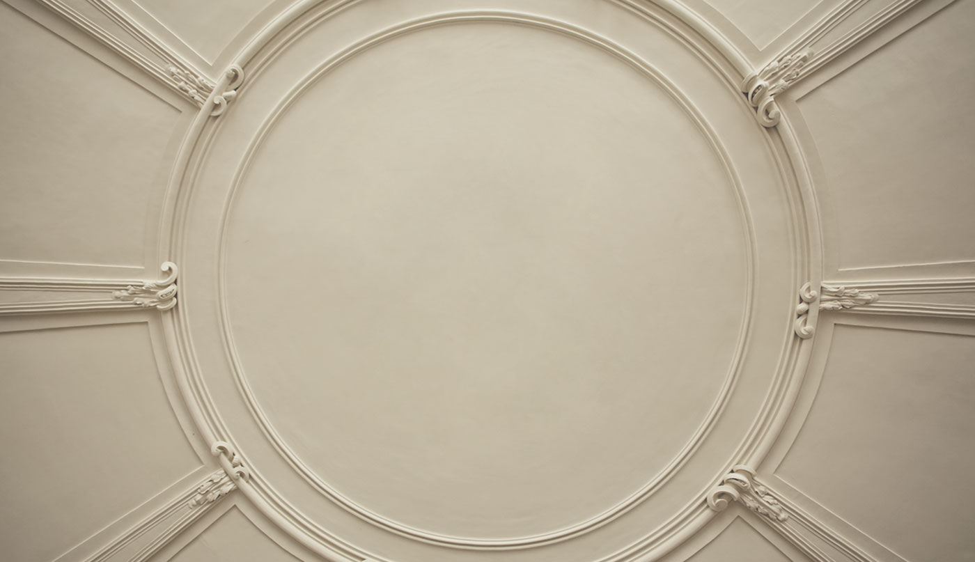 An off-white painted ceiling with decorative molding.