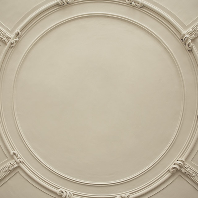 An off-white painted ceiling with decorative molding.