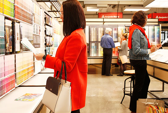 Customers shop in a Benjamin Moore store.