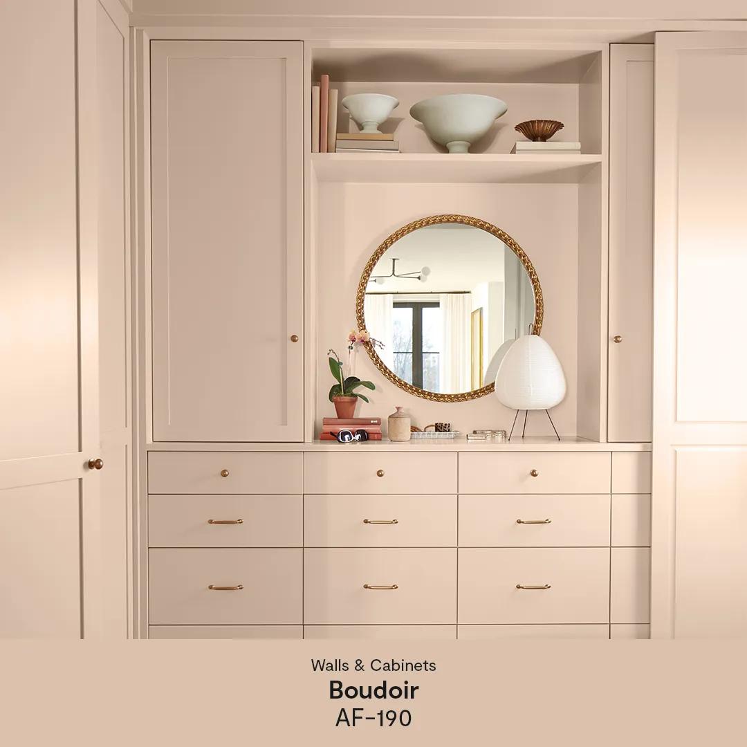 A corner of a room with built-in cabinets and drawers, walls, door and ceiling all painted in a soothing mid-tone with dusty rose undertones.