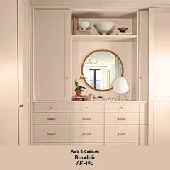 A corner of a room with built-in cabinets and drawers, walls, door and ceiling all painted in a soothing mid-tone with dusty rose undertones thumbnail.