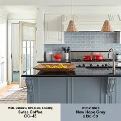 A white painted kitchen with an open back door, a blue-gray painted island with a black countertop, and a gray tile backsplash thumbnail.