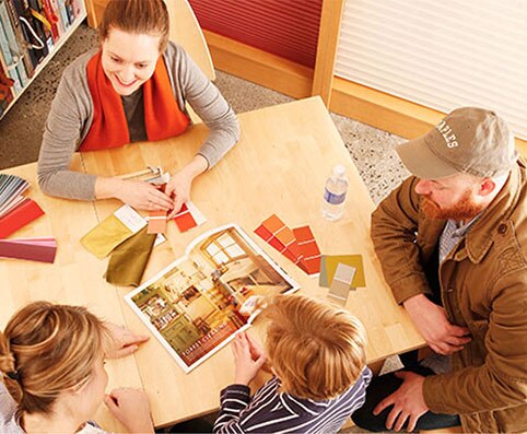 Customers discuss color options in a Benjamin Moore store